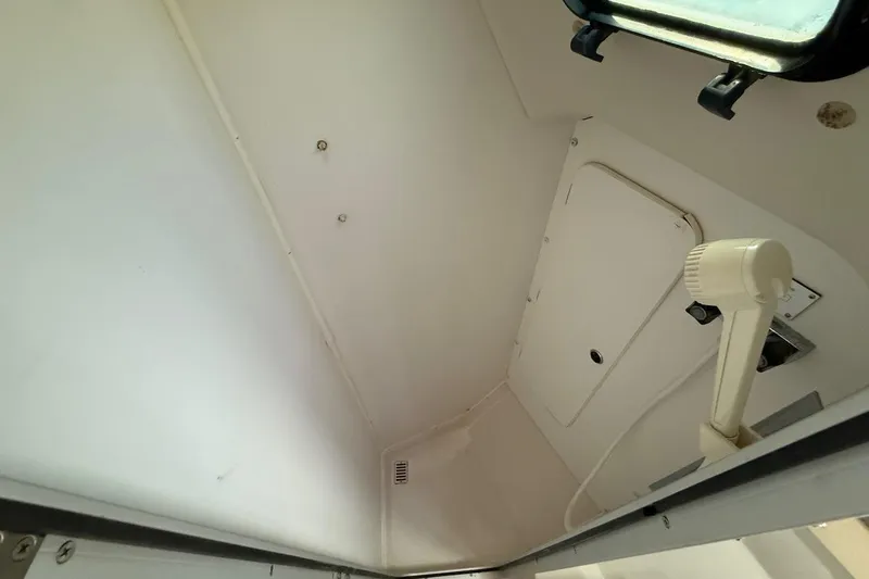 Slide: The Image of Interior of a 1998 Catalina 380 sailboat shower area with white walls and fixtures. - 38