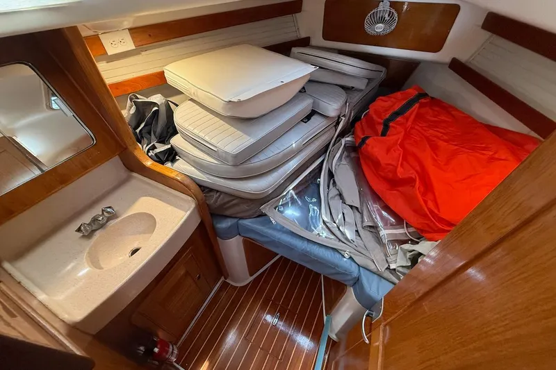 Slide: The Image of Interior of a 1998 Catalina 380 sailboat with cushions and gear stored. - 39