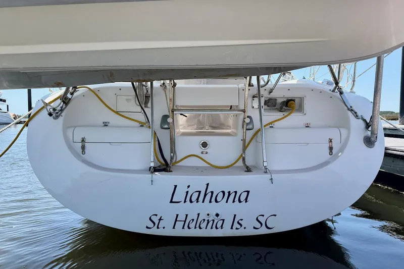Slide: The Image of Stern view of 1998 Catalina 380 sailboat named "Liahona" docked at St. Helena Island, SC. - 4