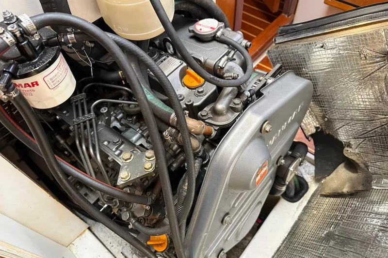 Slide: The Image of Engine compartment of a 1998 Catalina 380 sailboat, showcasing detailed mechanical components. - 44