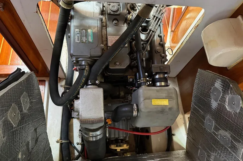 Slide: The Image of Engine compartment of a 1998 Catalina 380 sailboat, showcasing detailed mechanical components. - 45