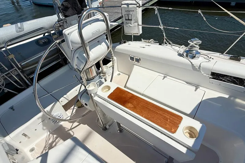 Slide: The Image of Cockpit of 1998 Catalina 380 sailboat with steering wheel and wooden table. - 7