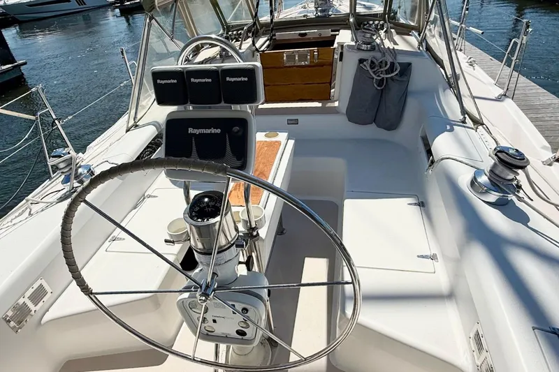Slide: The Image of Cockpit of a 1998 Catalina 380 sailboat with steering wheel and navigation equipment. - 8