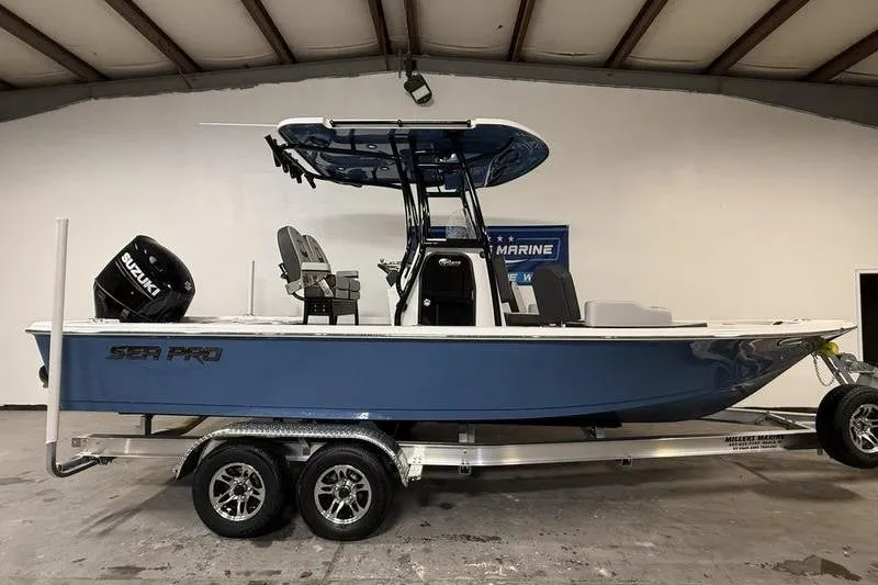 The Image of 2026 Sea Pro 230 Bay boat on trailer in indoor showroom. - 0