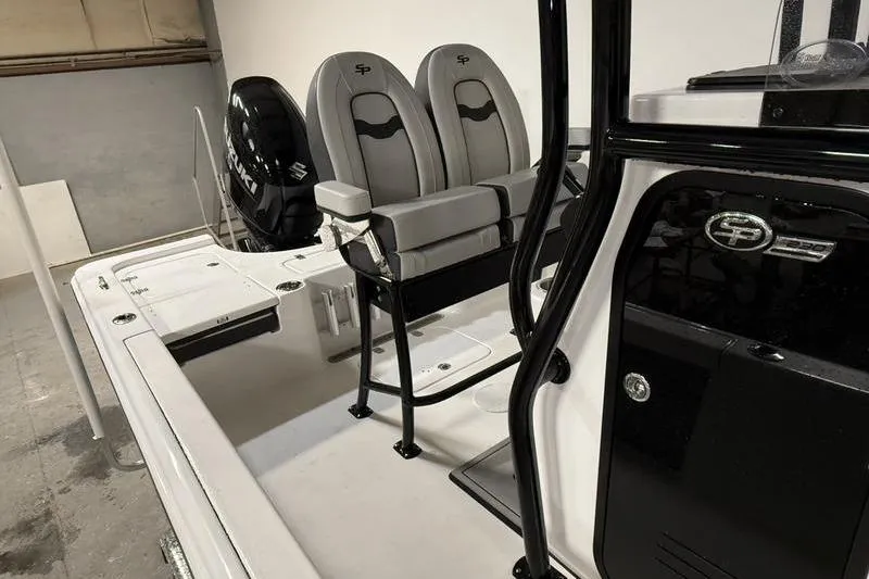 Slide: The Image of 2026 Sea Pro 230 Bay boat interior with dual seats and Suzuki engine. - 10