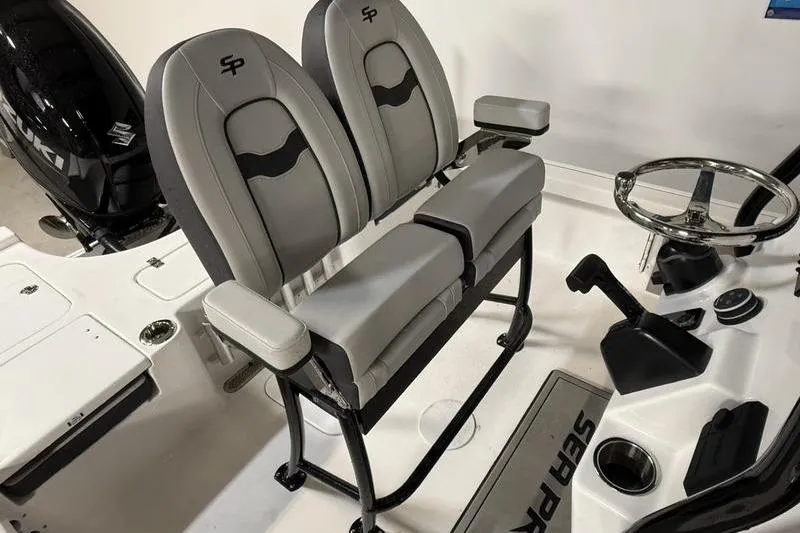 Slide: The Image of 2026 Sea Pro 230 Bay boat interior with dual seats and steering console. - 11