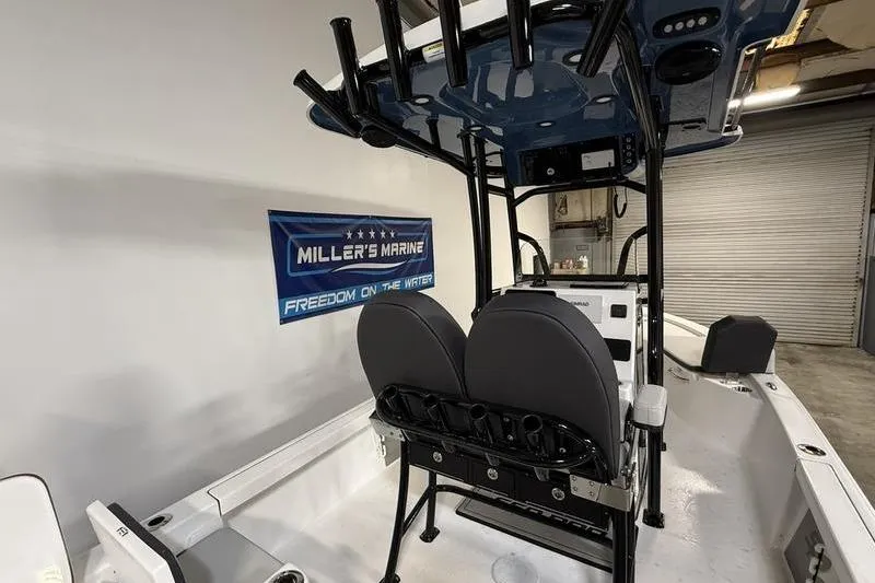 Slide: The Image of 2026 Sea Pro 230 Bay boat interior with seating and fishing rod holders. - 13