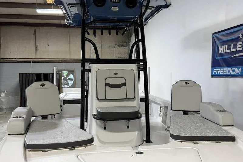 Slide: The Image of 2026 Sea Pro 230 Bay boat interior with seating and console in a showroom. - 17