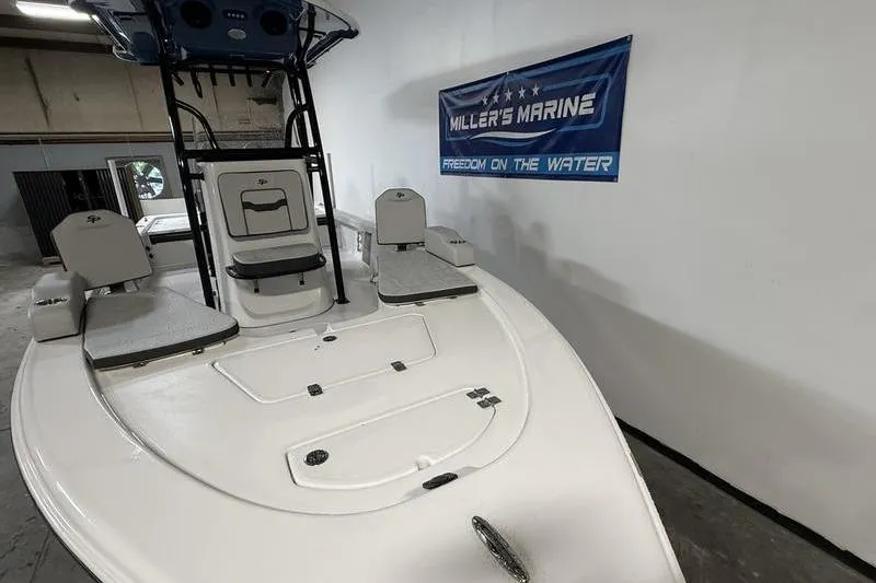 Slide: The Image of 2026 Sea Pro 230 Bay boat displayed indoors at Miller's Marine. - 18