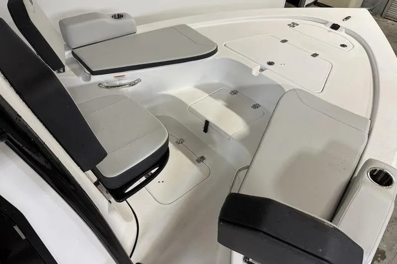 Slide: The Image of Interior view of 2026 Sea Pro 230 Bay boat with cushioned seating and storage compartments. - 19