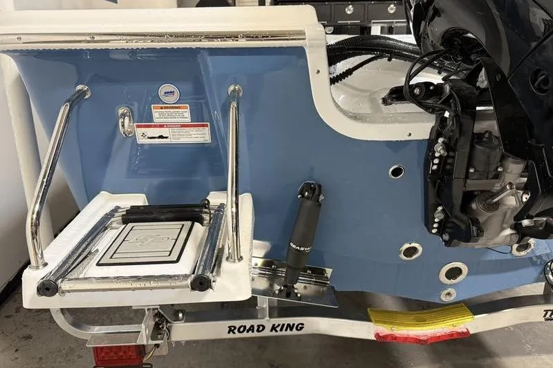 Slide: The Image of 2026 Sea Pro 230 Bay boat stern with motor and swim ladder on trailer. - 4