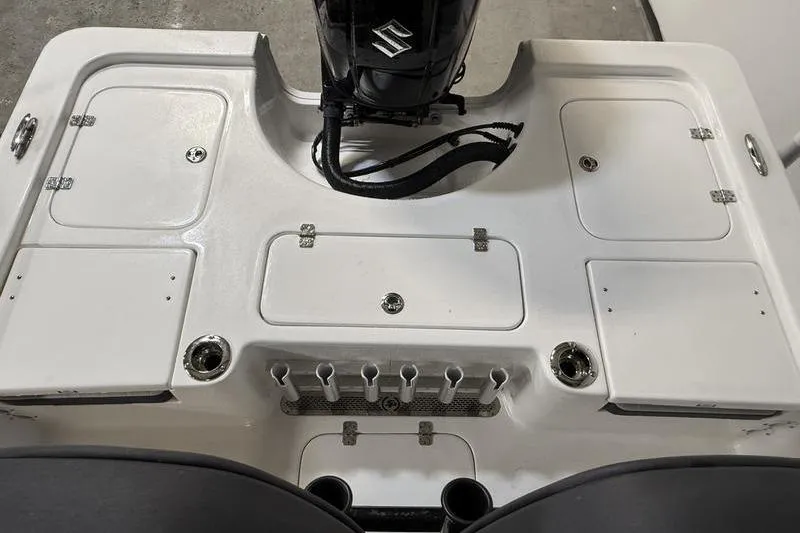 Slide: The Image of 2026 Sea Pro 230 Bay boat deck with Suzuki engine and storage compartments. - 6