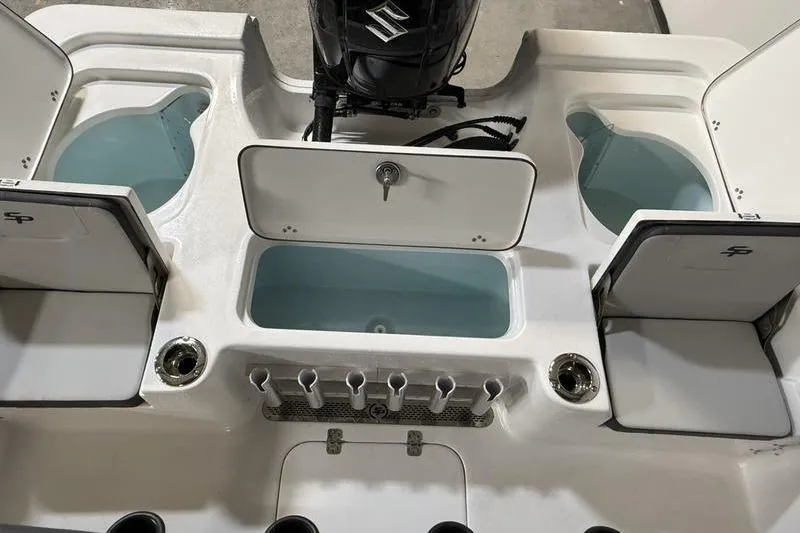 Slide: The Image of 2026 Sea Pro 230 Bay boat interior with storage compartments and Suzuki engine. - 7