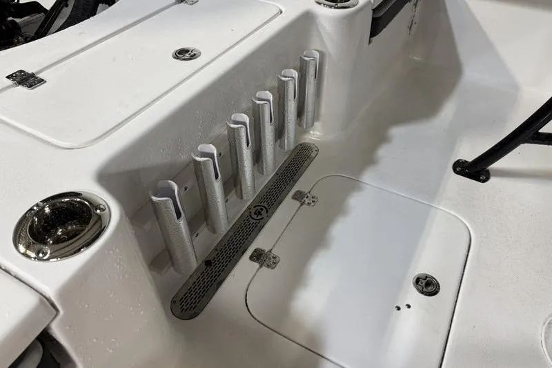 Slide: The Image of 2026 Sea Pro 230 Bay boat interior with rod holders and storage compartments. - 9