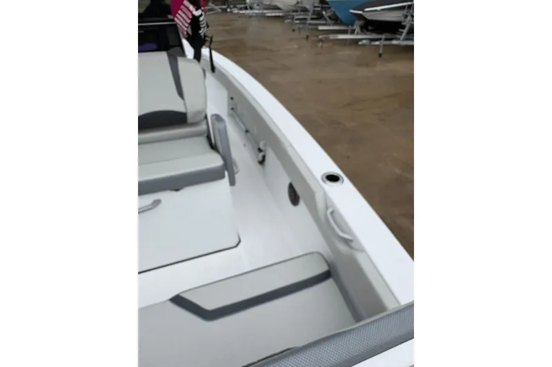 Slide: The Image of 2024 Scarab 235 ID boat interior with gray seating and white deck. - 12
