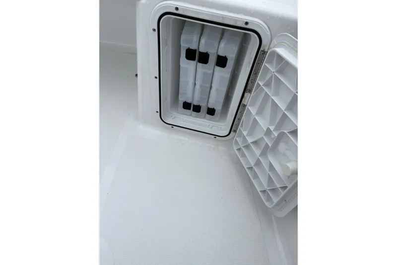 Slide: The Image of Open storage compartment on 2024 Scarab 235 ID boat, showcasing interior design. - 15
