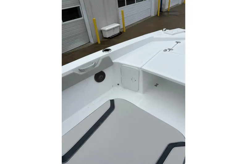 Slide: The Image of 2024 Scarab 235 ID boat interior, featuring sleek white design and modern amenities. - 16