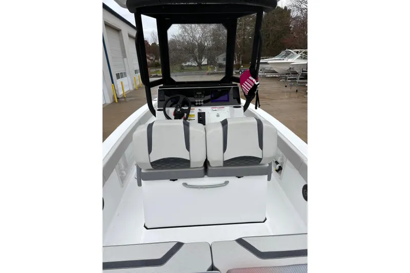 Slide: The Image of 2024 Scarab 235 ID boat interior with dual seats and steering console. - 5