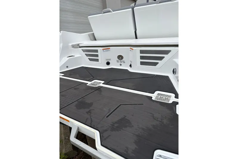 Slide: The Image of 2024 Scarab 235 ID boat deck with sleek black flooring and modern design. - 6