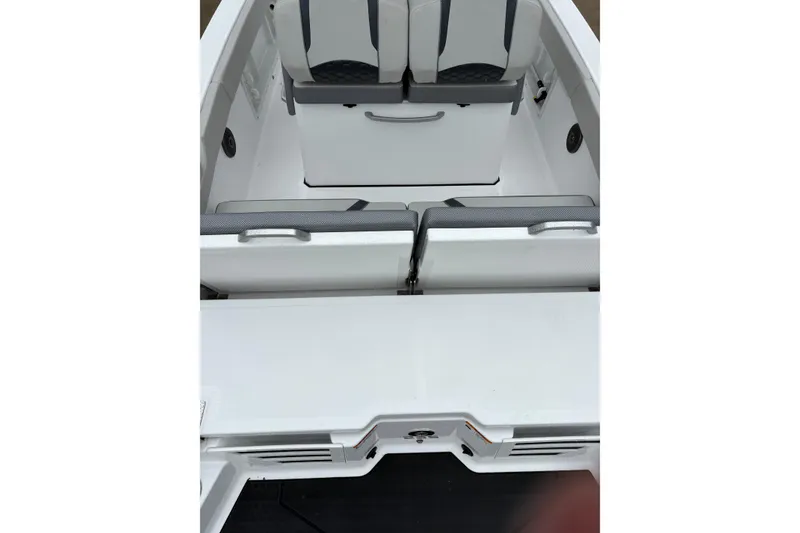 Slide: The Image of 2024 Scarab 235 ID boat interior with white seating and storage compartments. - 9