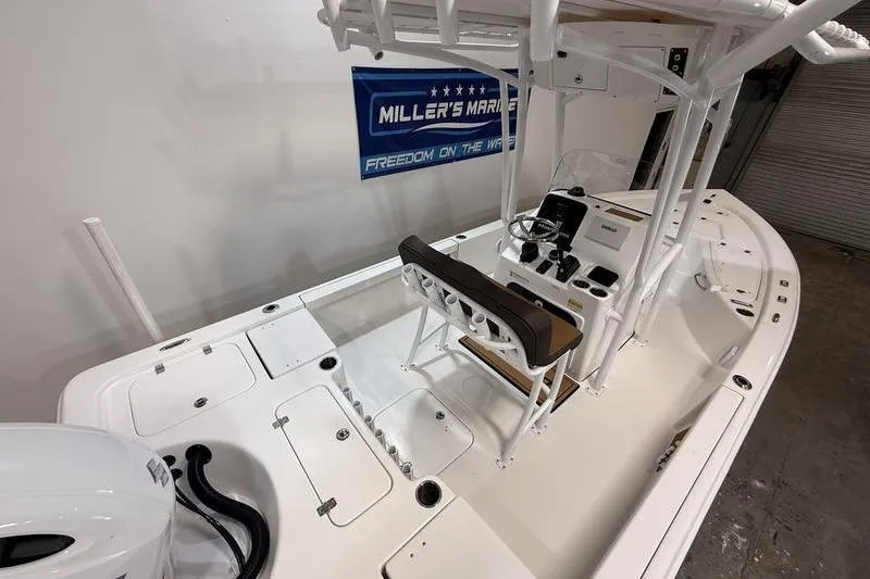 Slide: The Image of 2026 Sea Pro 230 Bay boat interior with helm, seating, and storage compartments. - 10