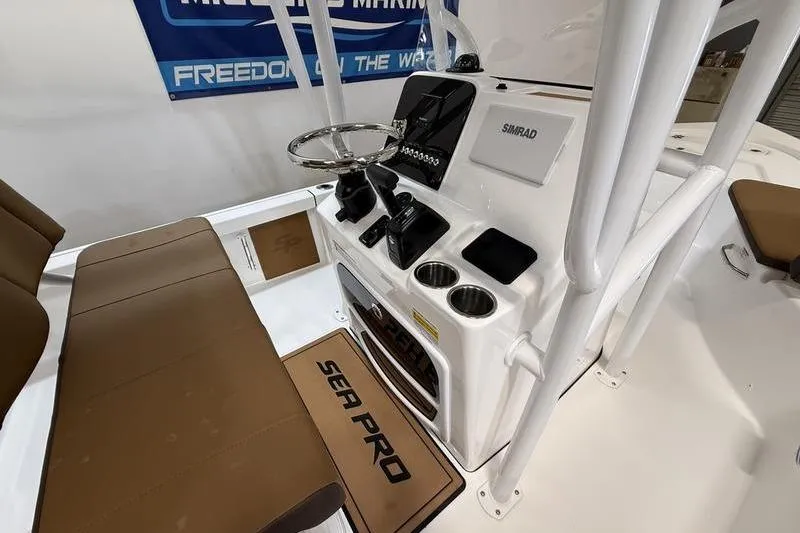 Slide: The Image of 2026 Sea Pro 230 Bay boat interior with steering console and seating. - 12
