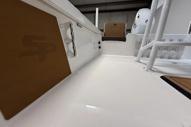 Slide: The Image of 2026 Sea Pro 230 Bay boat interior with white deck and brown accents. - 14