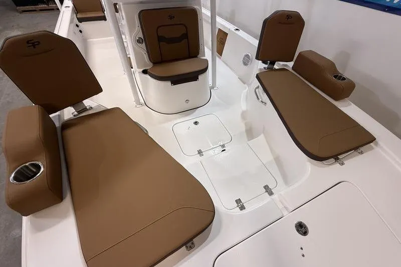 Slide: The Image of 2026 Sea Pro 230 Bay boat interior with brown cushioned seating and white deck. - 19