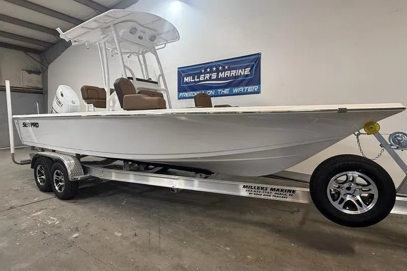 Slide: The Image of 2026 Sea Pro 230 Bay boat on trailer at Miller's Marine showroom. - 2