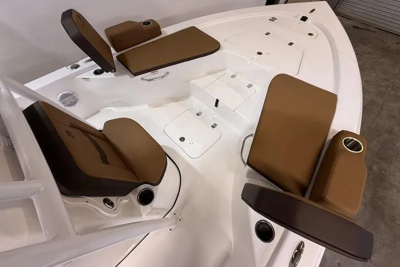 Slide: The Image of 2026 Sea Pro 230 Bay boat interior with brown cushioned seating and storage compartments. - 20