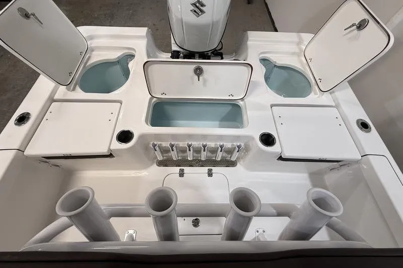 Slide: The Image of 2026 Sea Pro 230 Bay boat deck with storage compartments and rod holders. - 6