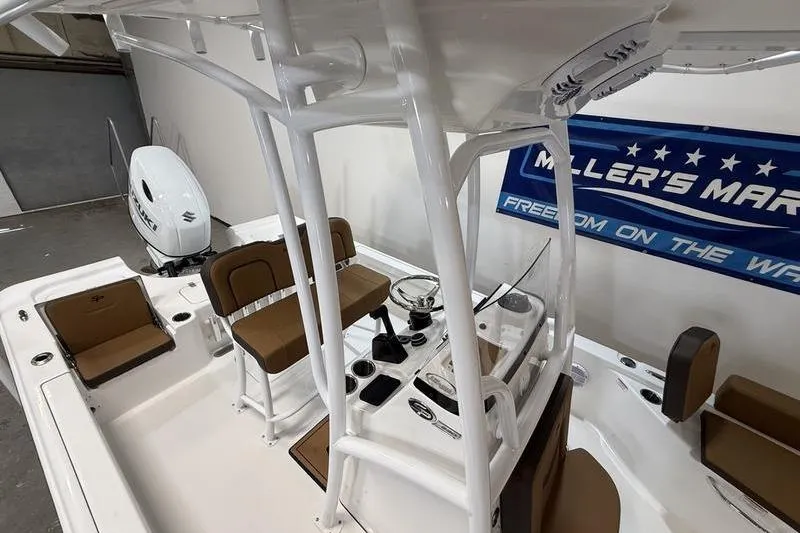Slide: The Image of 2026 Sea Pro 230 Bay boat interior with seating and console, displayed indoors. - 9