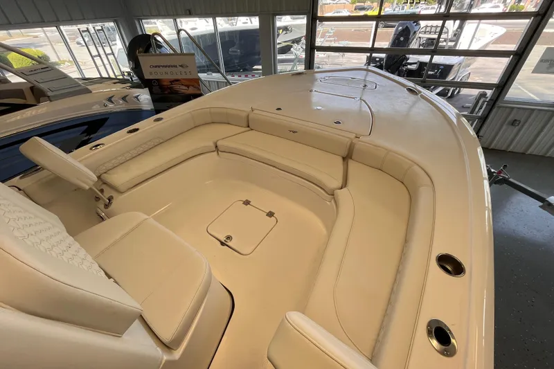 Slide: The Image of 2026 Tidewater 2500 Carolina Bay boat interior with beige seating and storage compartments. - 10