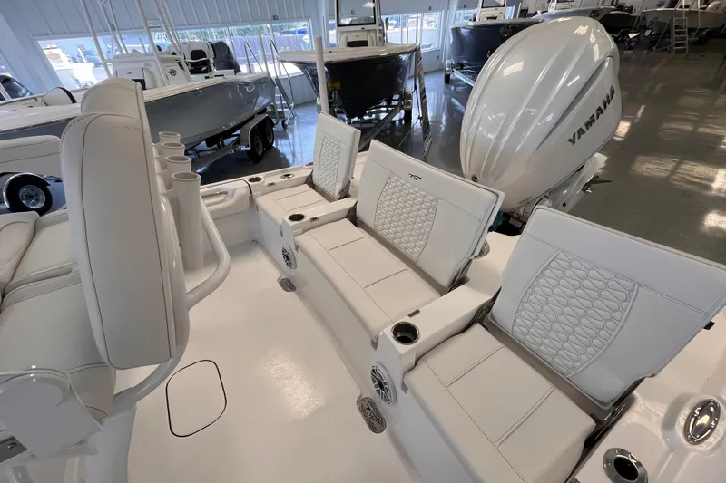 Slide: The Image of 2026 Tidewater 2500 Carolina Bay boat interior with Yamaha engine, featuring white cushioned seating. - 15