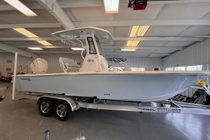 Slide: The Image of 2026 Tidewater 2500 Carolina Bay boat on trailer in indoor showroom. - 3