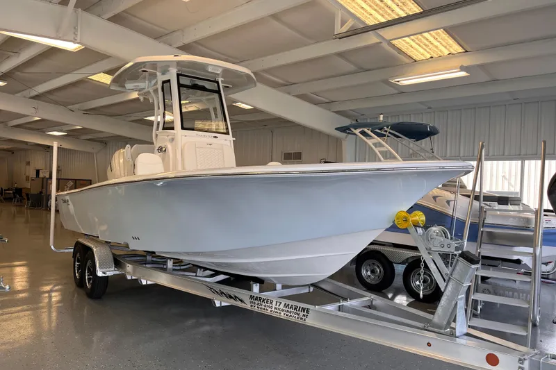 Slide: The Image of 2026 Tidewater 2500 Carolina Bay boat on trailer in indoor showroom. - 4