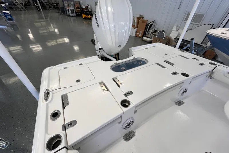 Slide: The Image of 2026 Tidewater 2500 Carolina Bay boat deck with storage compartments and Yamaha engine. - 5
