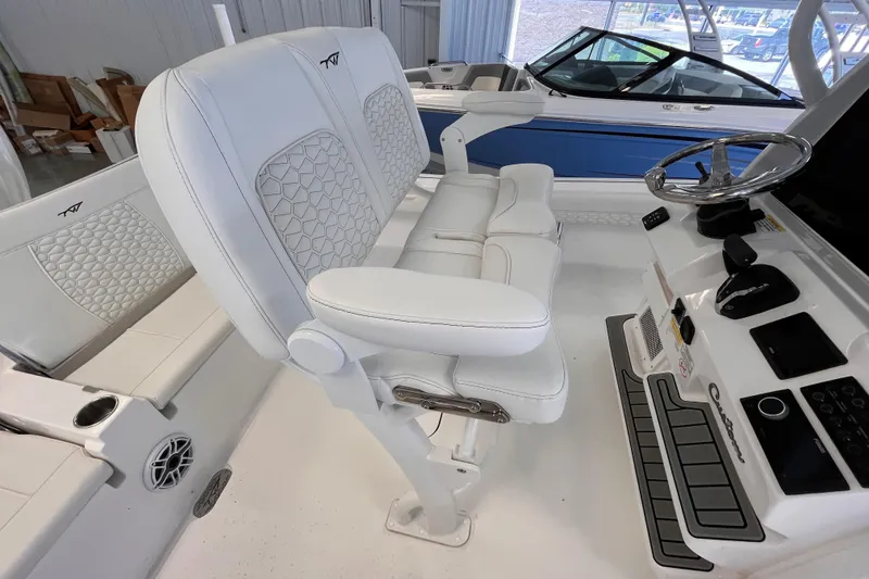 Slide: The Image of 2026 Tidewater 2500 Carolina Bay boat interior with white seating and steering console. - 7