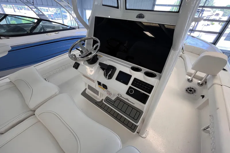 Slide: The Image of Interior view of 2026 Tidewater 2500 Carolina Bay boat cockpit with steering wheel and controls. - 8