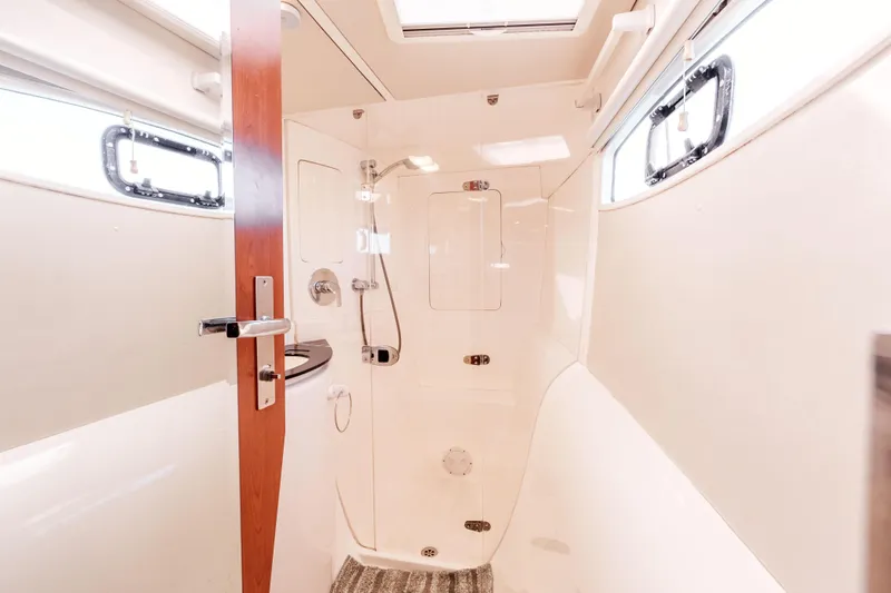 Slide: The Image of Interior of 2011 Leopard 39 yacht bathroom with shower and wooden door. - 19