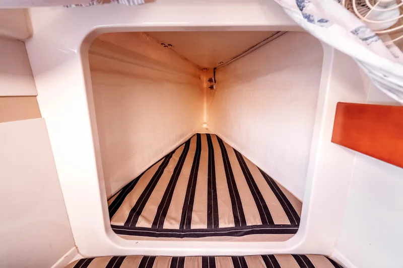 Slide: The Image of Interior view of a 2011 Leopard 39 yacht cabin with striped bedding. - 22