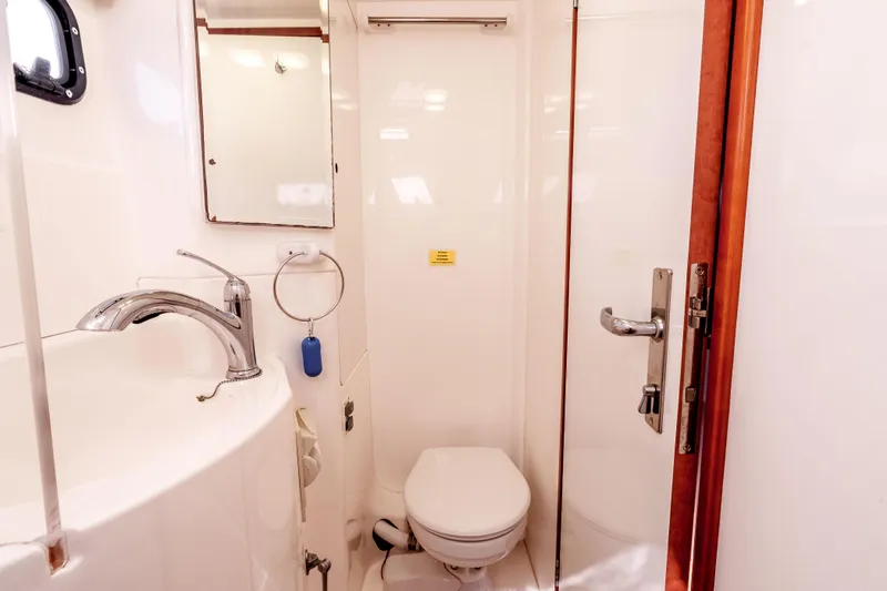 Slide: The Image of Bathroom interior of 2011 Leopard 39 yacht with sink, toilet, and shower. - 27
