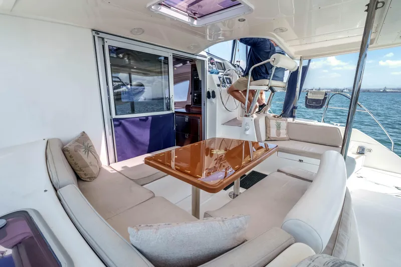 Slide: The Image of Luxurious 2011 Leopard 39 yacht interior with plush seating and elegant wooden table. - 6