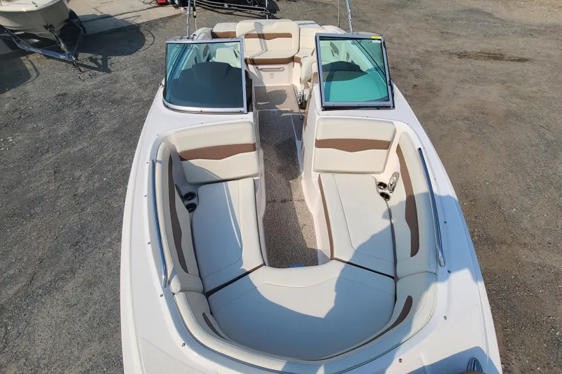 Slide: The Image of 2014 Chaparral 246 SSi boat interior with beige seating and open windshield. - 10