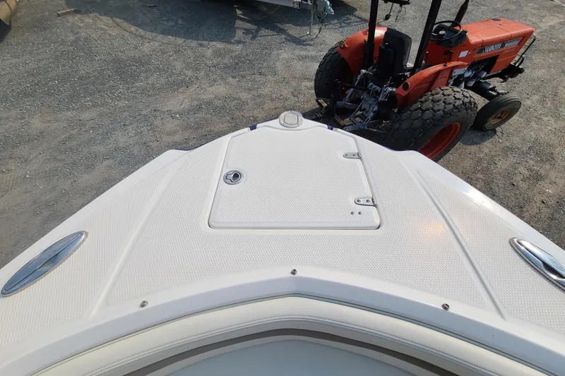 Slide: The Image of Bow view of 2014 Chaparral 246 SSi boat with tractor in background. - 12