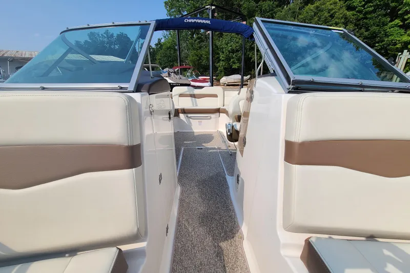 Slide: The Image of 2014 Chaparral 246 SSi boat interior with beige and brown seating, open windshield. - 14
