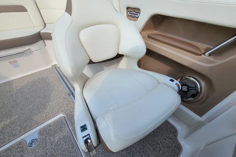 Slide: The Image of 2014 Chaparral 246 SSi boat interior with beige seating and carpeted flooring. - 16