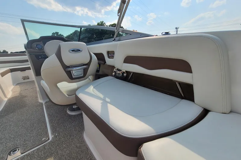 Slide: The Image of Interior of a 2014 Chaparral 246 SSi boat with beige seating and dashboard. - 17