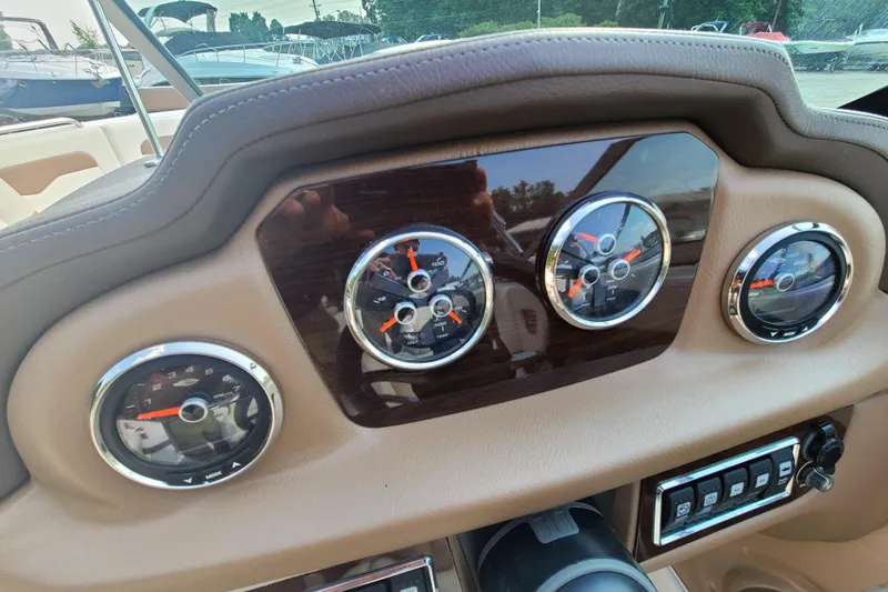 Slide: The Image of Dashboard of a 2014 Chaparral 246 SSi boat with gauges and controls. - 21