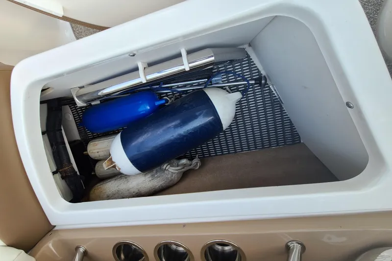 Slide: The Image of Storage compartment in 2014 Chaparral 246 SSi boat with fenders and accessories. - 26